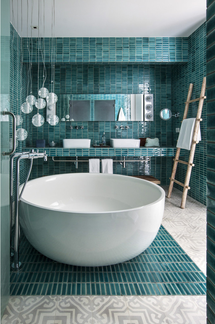 Ванные комнаты облицованы плиткой, покрытой глазурью. Светильники по форме перекликаются с ванной.